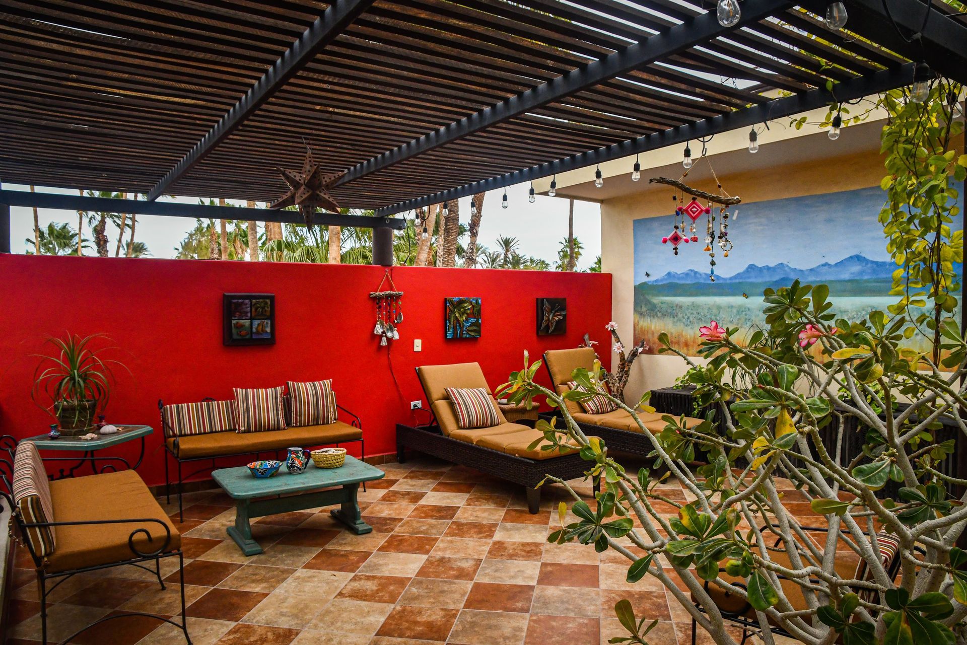 A patio with a couch and chairs under a pergola