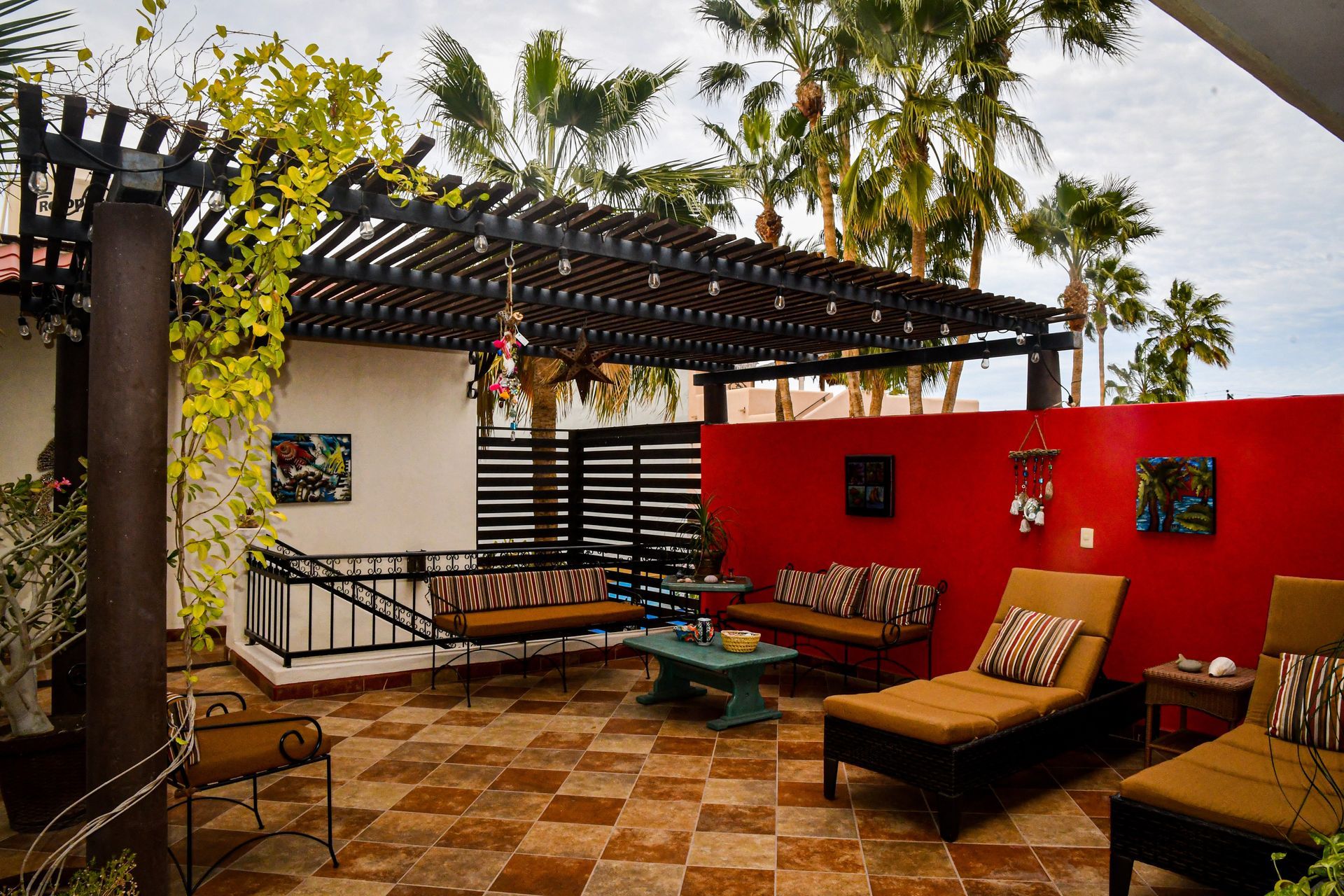A patio with chairs , a table and a pergola