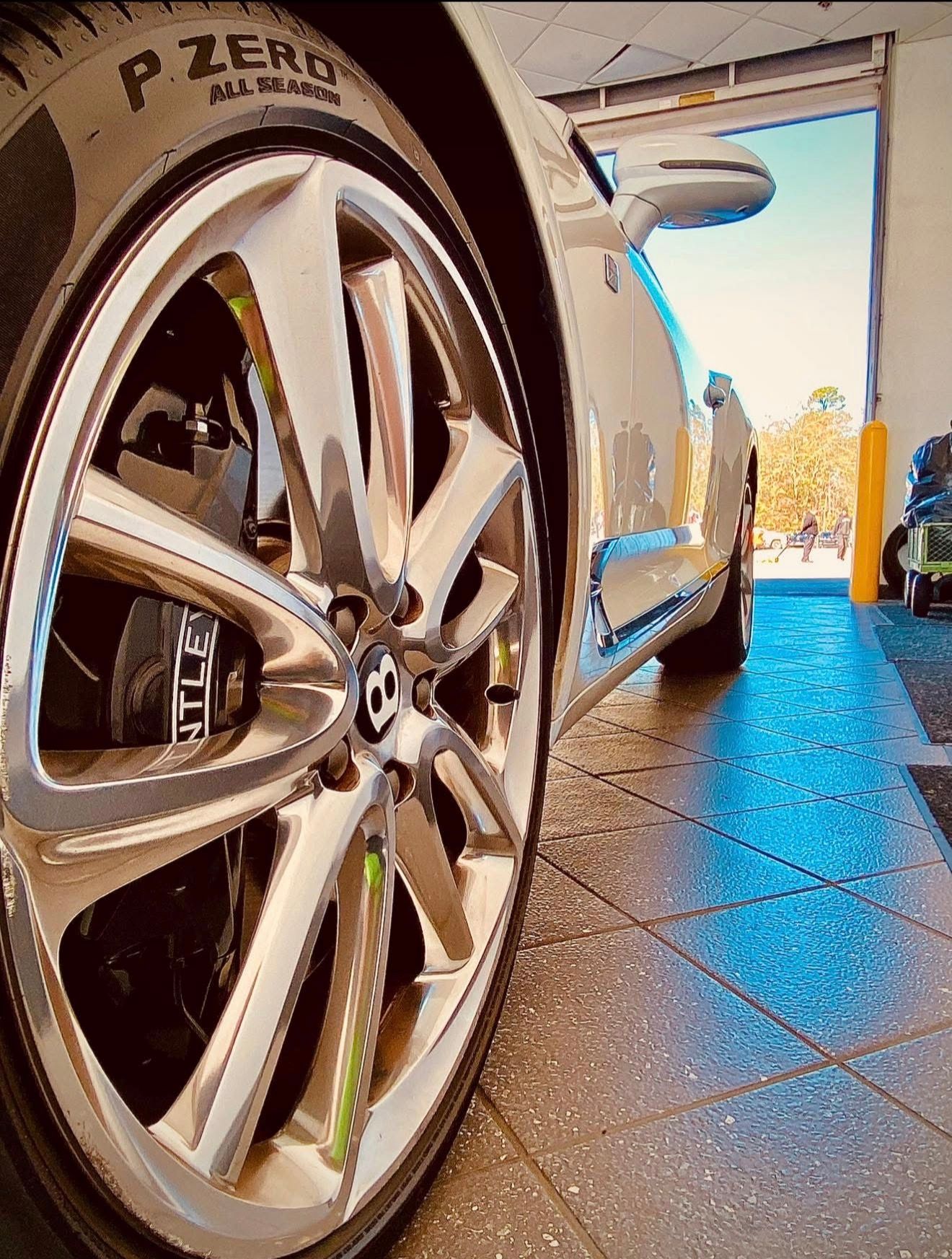 upshot Picture of a Bentley, left from wheel, Charleston dent company having just removed a dent using the PDR process. 