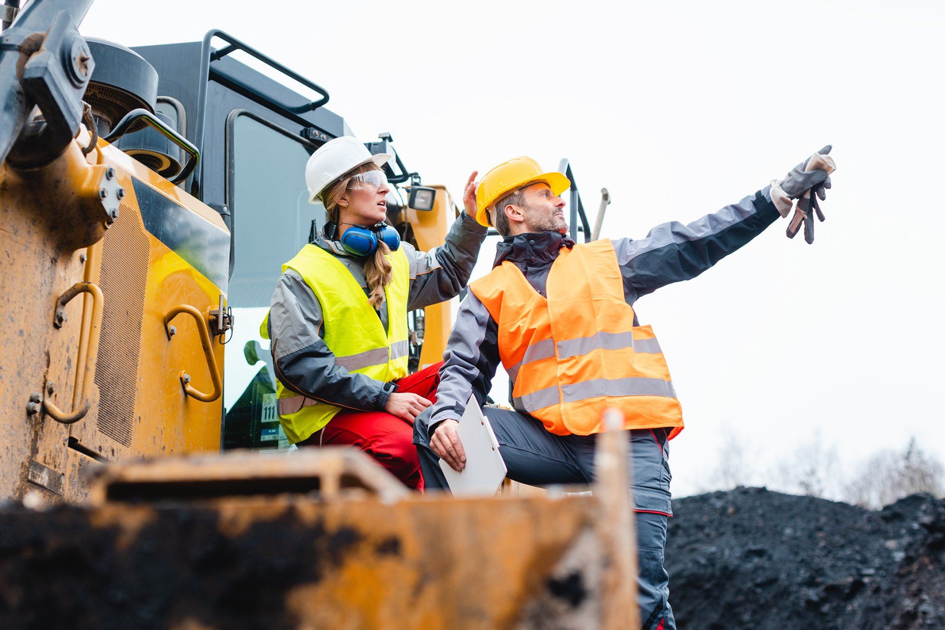man woman workers on excavator quarry