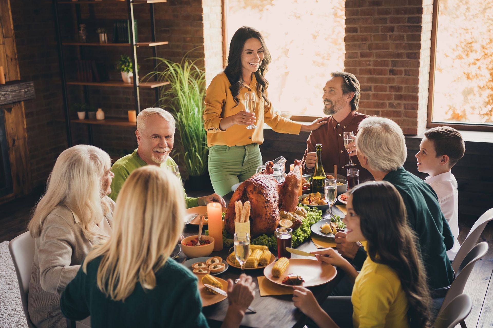 nice attractive adorable cheerful family small little kids meeting mom saying toast congratulating harvest festal event occasion at modern loft industrial wooden interior house