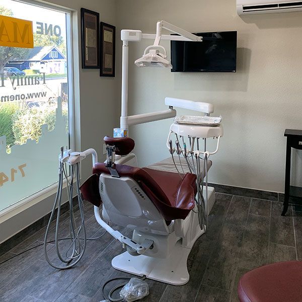 A dental office with a dental chair and a television
