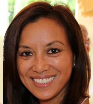 A close-up of a woman's face with a smile on her face