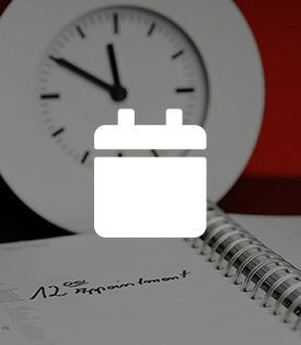 A clock is sitting on top of a notebook