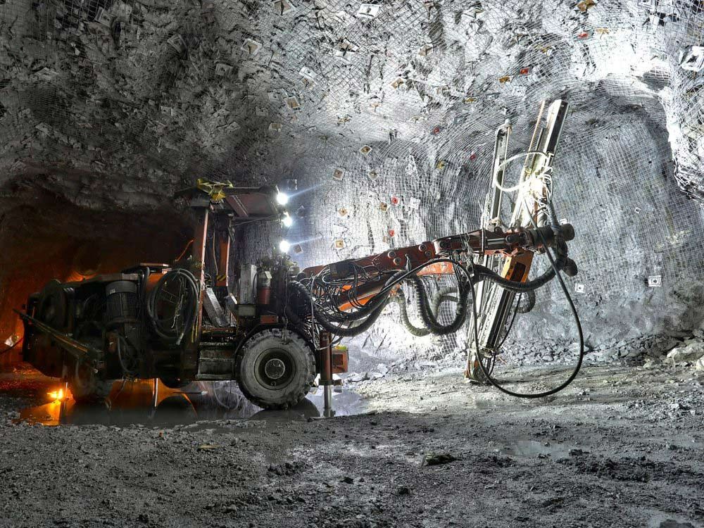 Mining Machine Drilling Into a Rock Wall in an Underground Tunnel — Secure Mine Solutions in Port Ryan, QLD