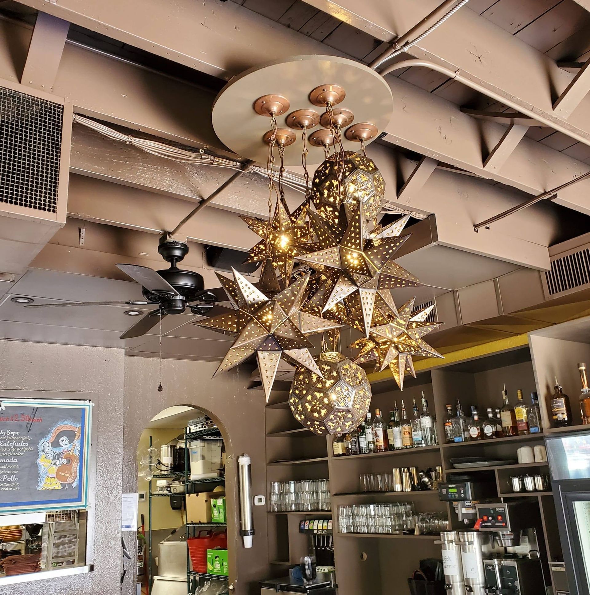 A restaurant with a chandelier hanging from the ceiling