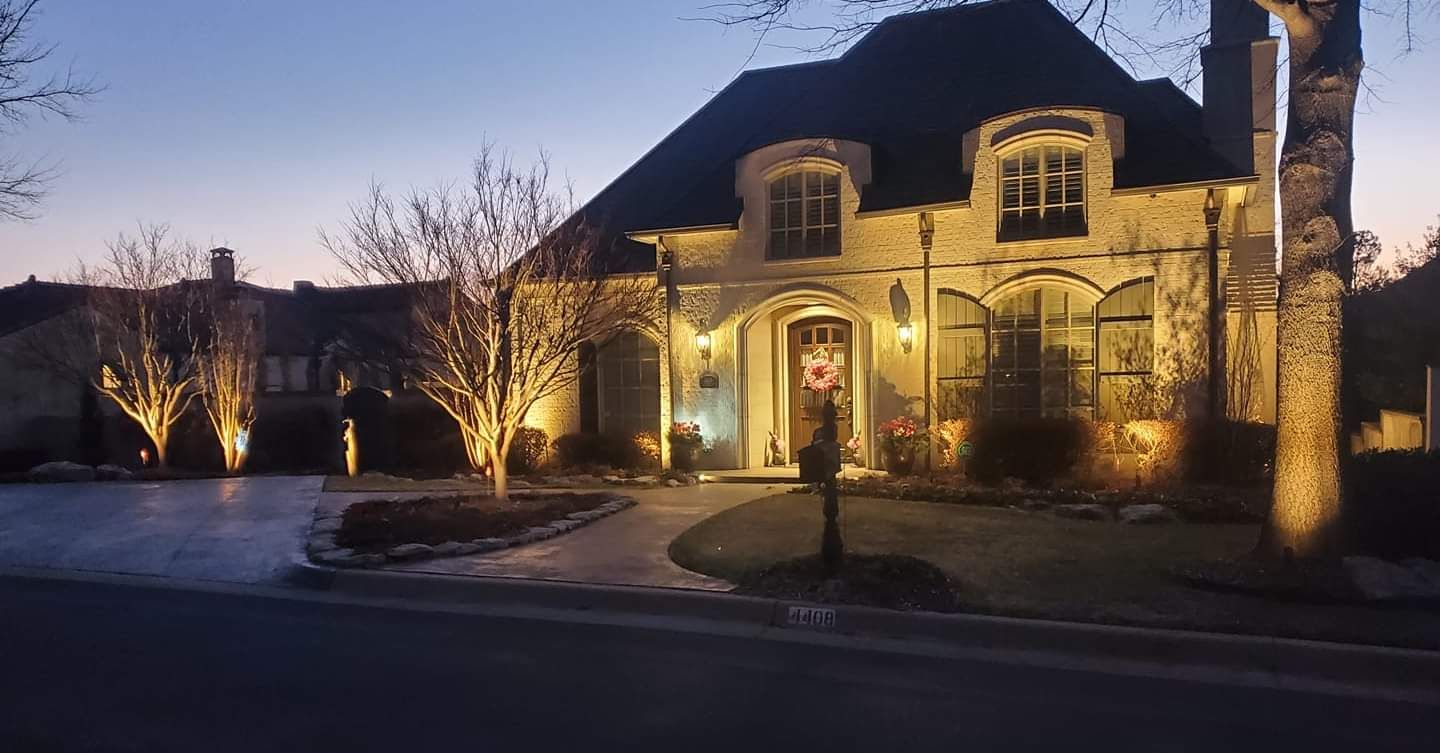 A large house is lit up at night with christmas lights.