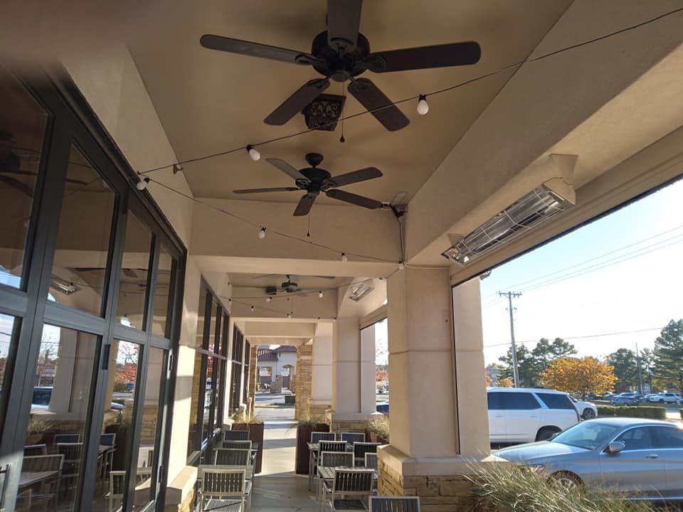 A ceiling fan is hanging from the ceiling of a building