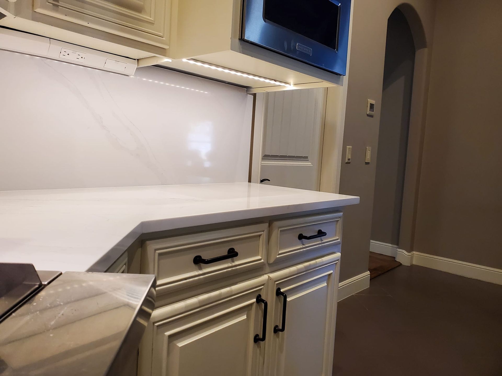 A kitchen with white cabinets and stainless steel appliances.