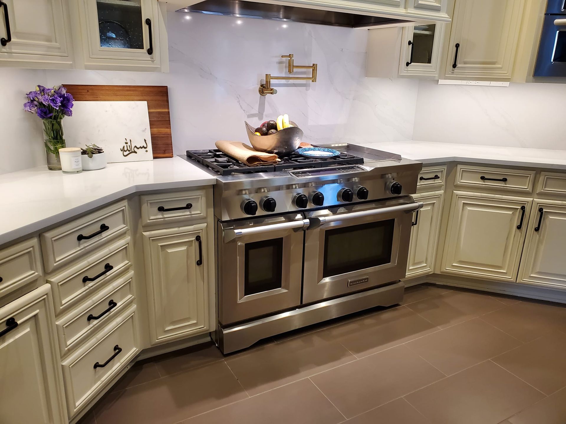 A kitchen with stainless steel appliances and white cabinets.