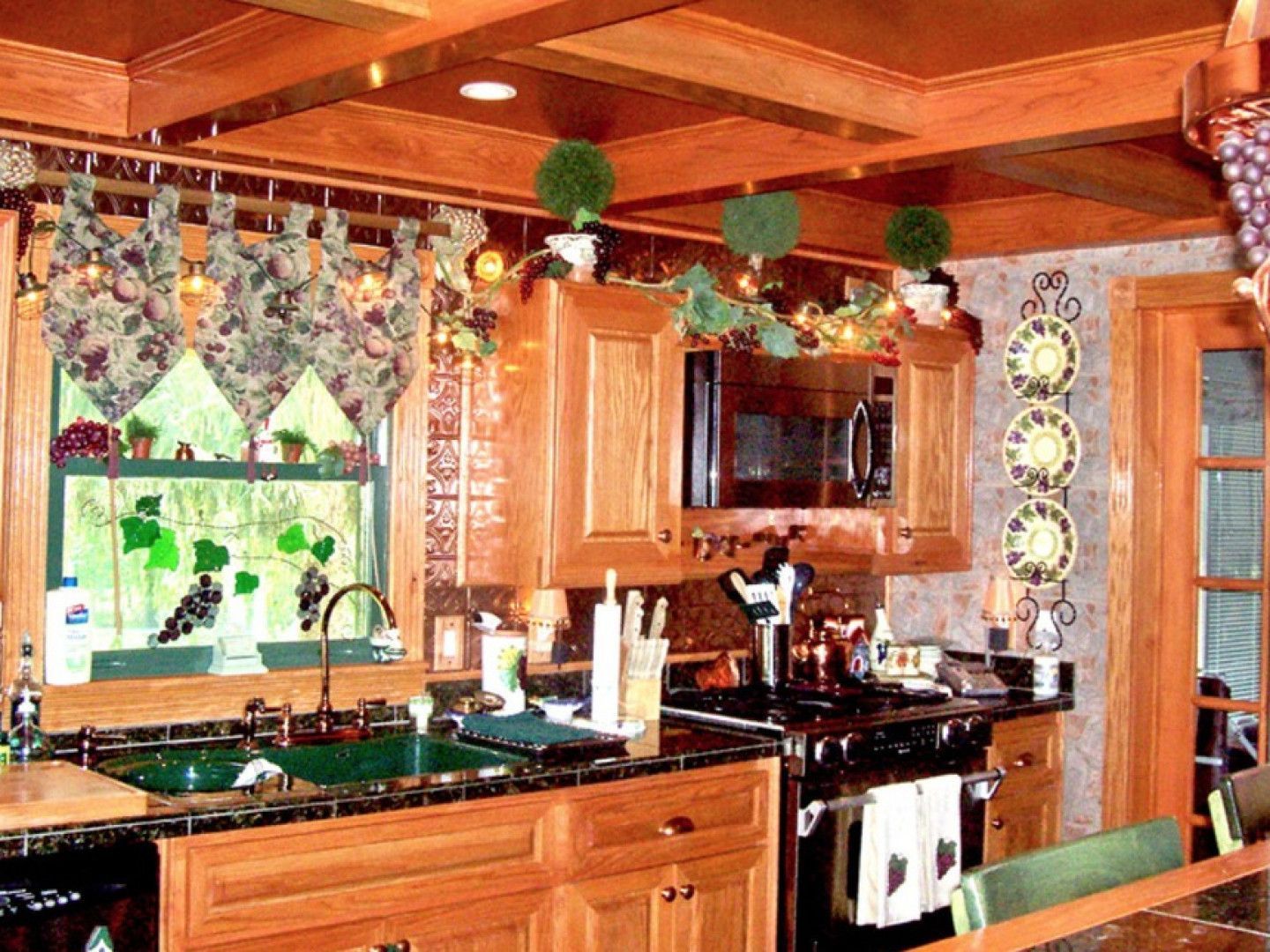 A kitchen with a sink stove and microwave