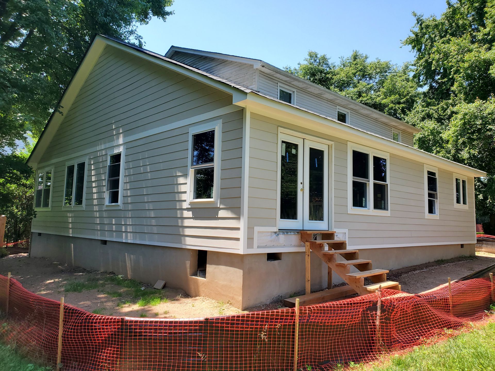 A house under construction with a red fence around it