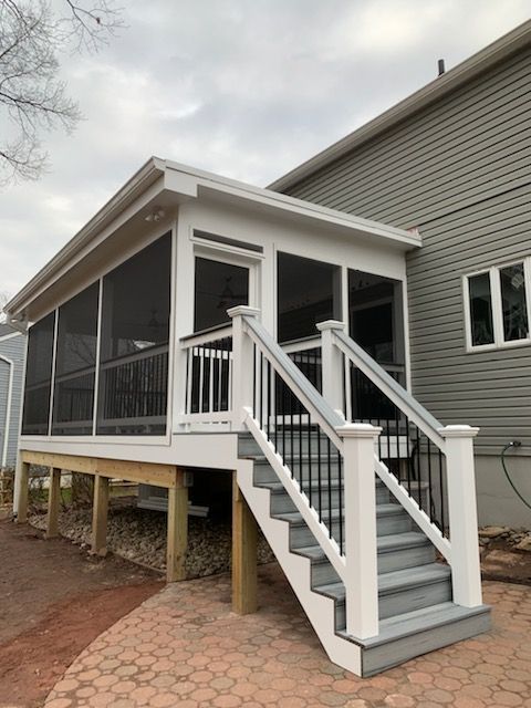 A screened in porch with stairs leading up to it