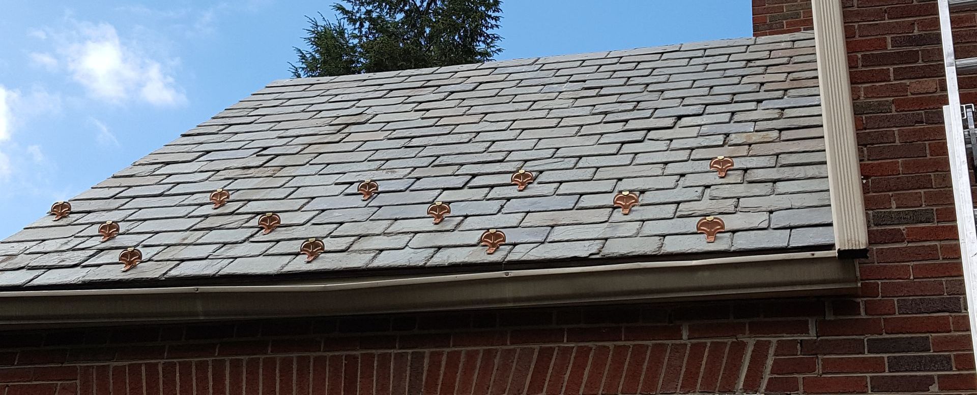 A brick building with a roof that has a lot of shingles on it