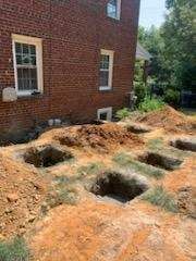 A brick building with a lot of dirt in front of it.