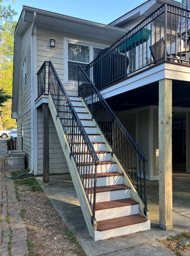 A house with a balcony and stairs leading up to it.