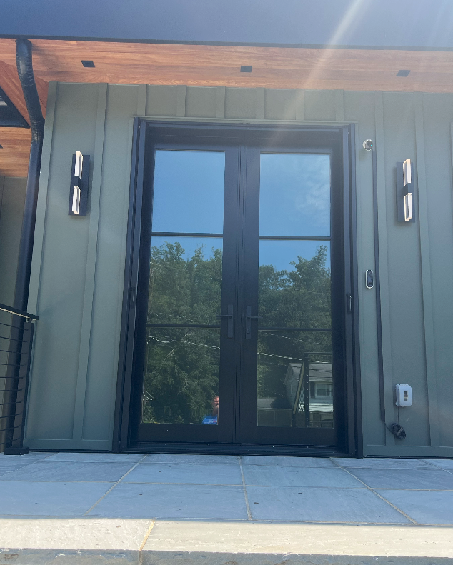 A house with a reflection of trees in the windows