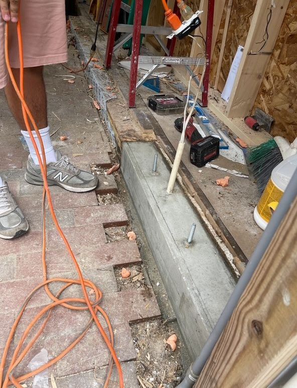 Person working on a construction project with tools and wooden planks.