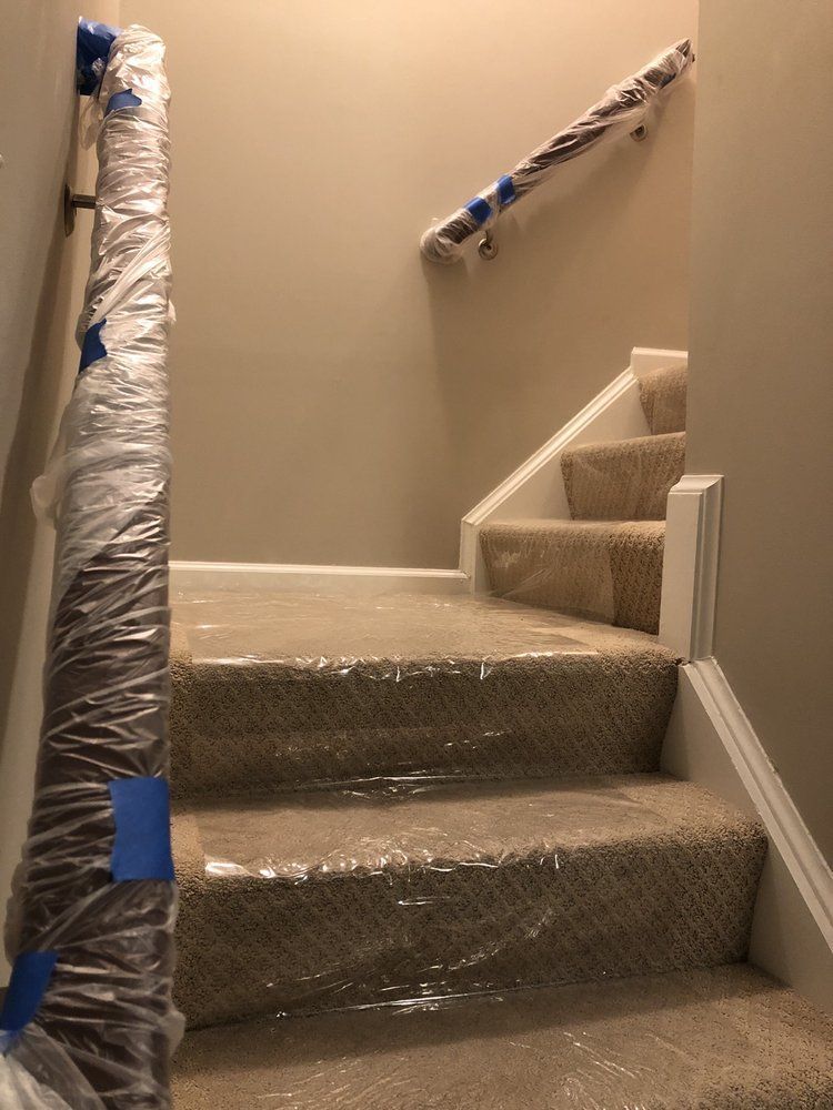 The stairs are wrapped in plastic and ready to be painted.