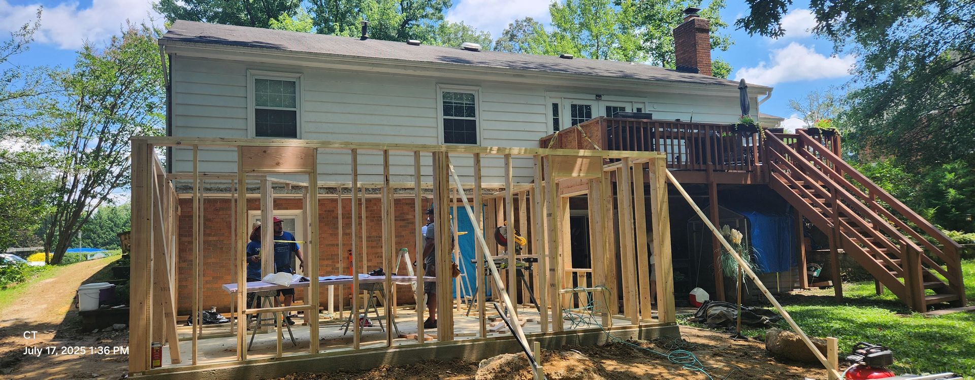 A ladder is sitting on top of a wooden structure under construction.