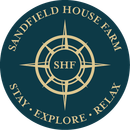 The logo for sandfield house farm says to stay explore and relax