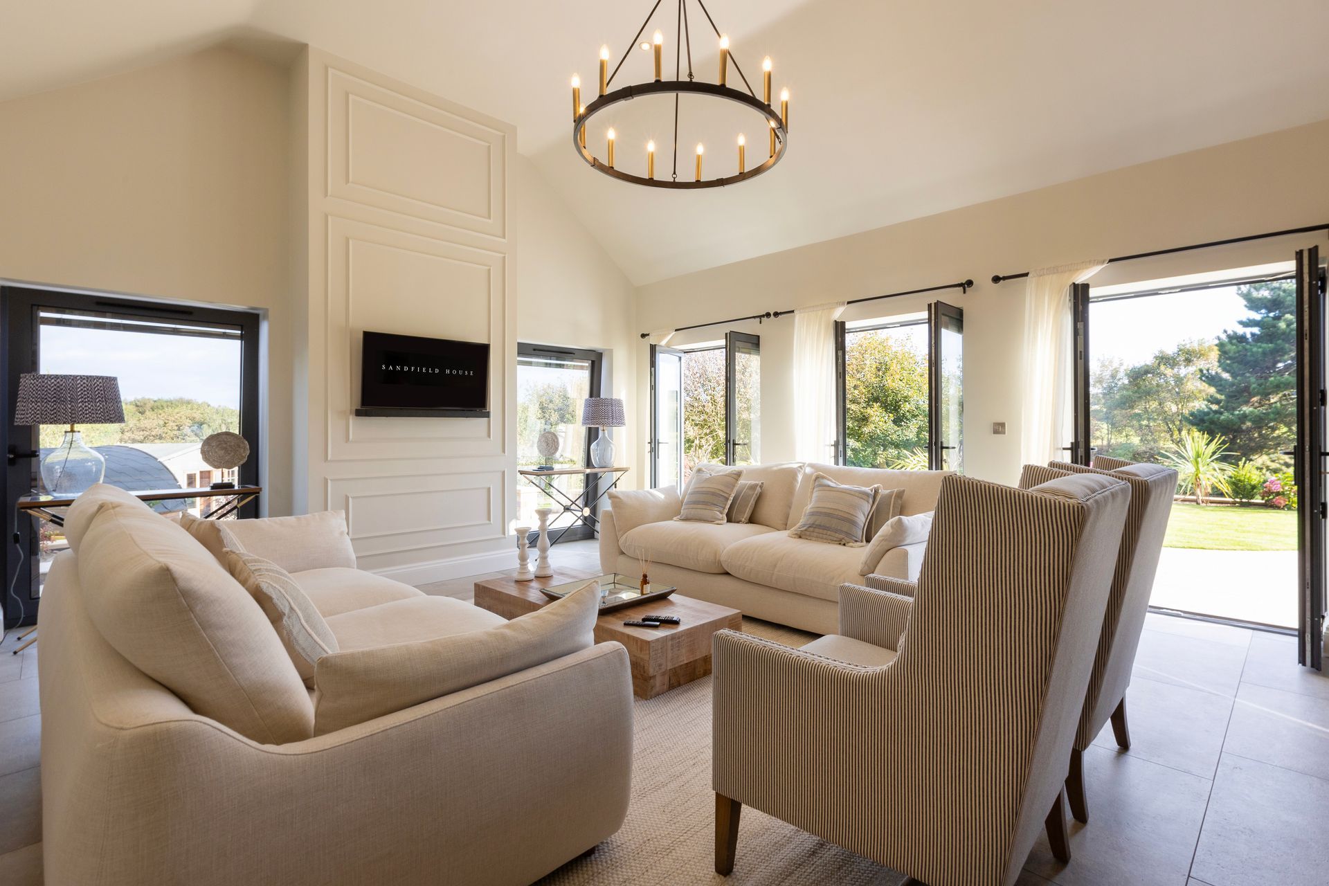 A living room filled with furniture and a chandelier.