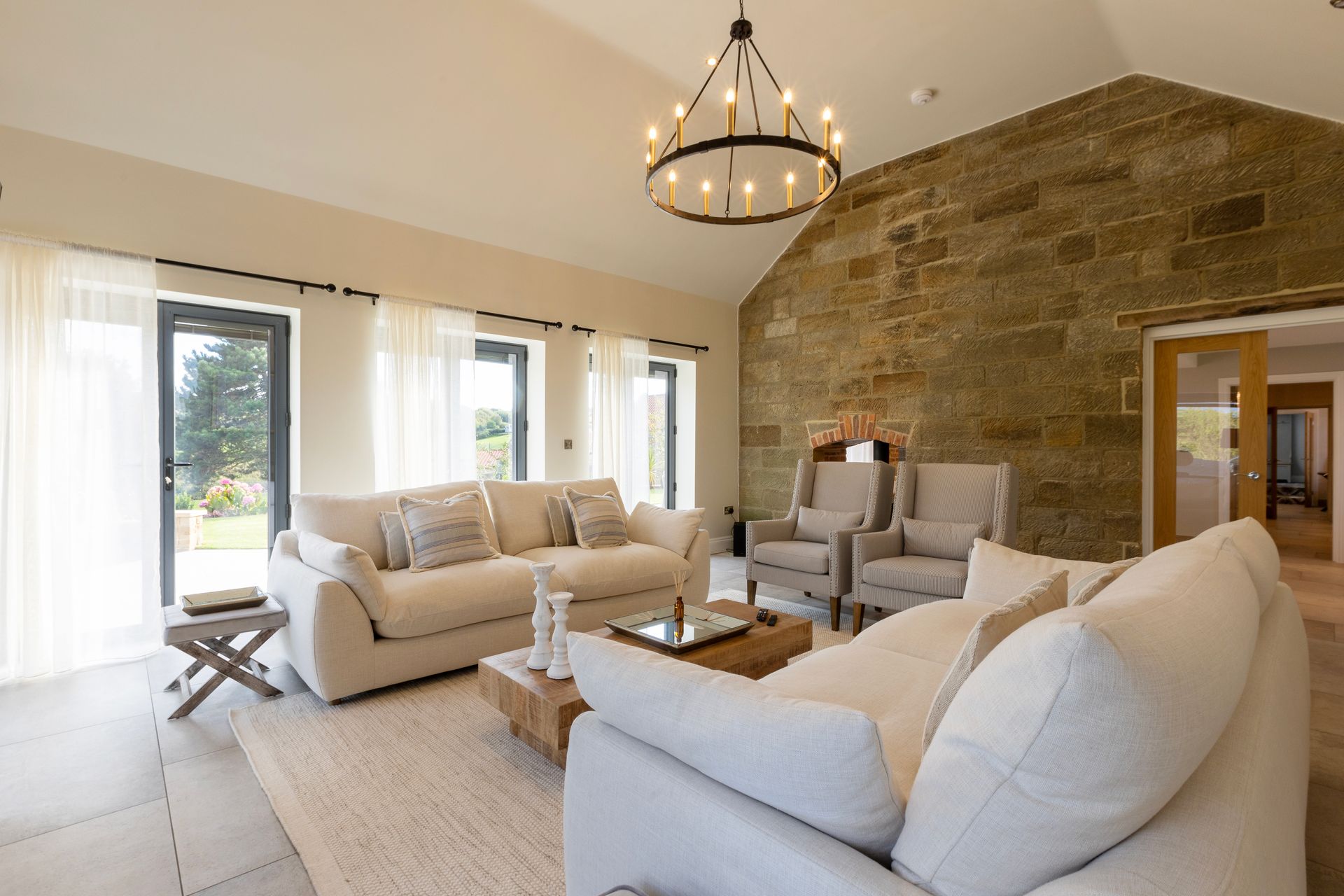 A living room filled with furniture and a chandelier.
