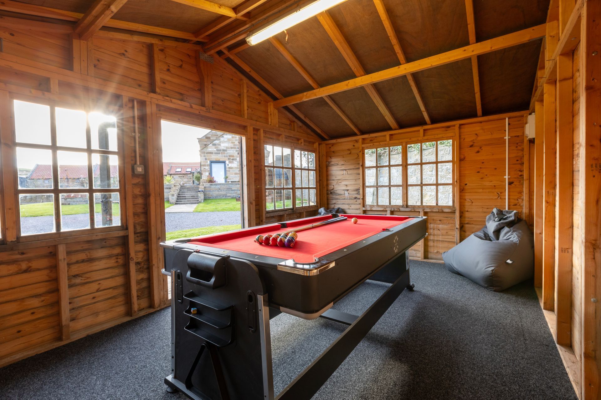 There is a pool table in the middle of the room.