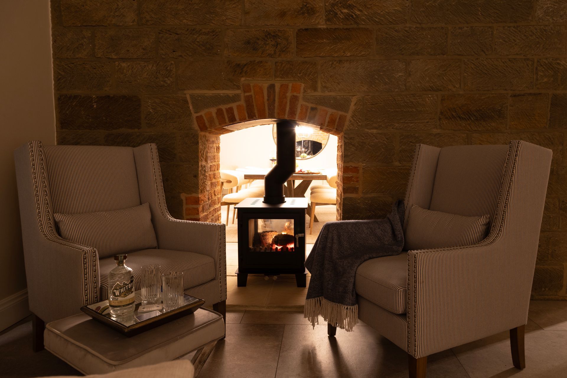 Two chairs are sitting in front of a fireplace in a living room.