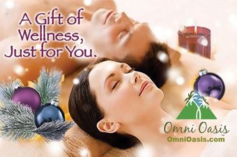 Woman receiving a massage with spa items: leaves, essential oils, cinnamon, cloves, and candle.