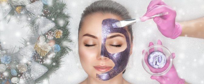 Couple receiving massages on their backs in a spa; lit candles and dried petals present.