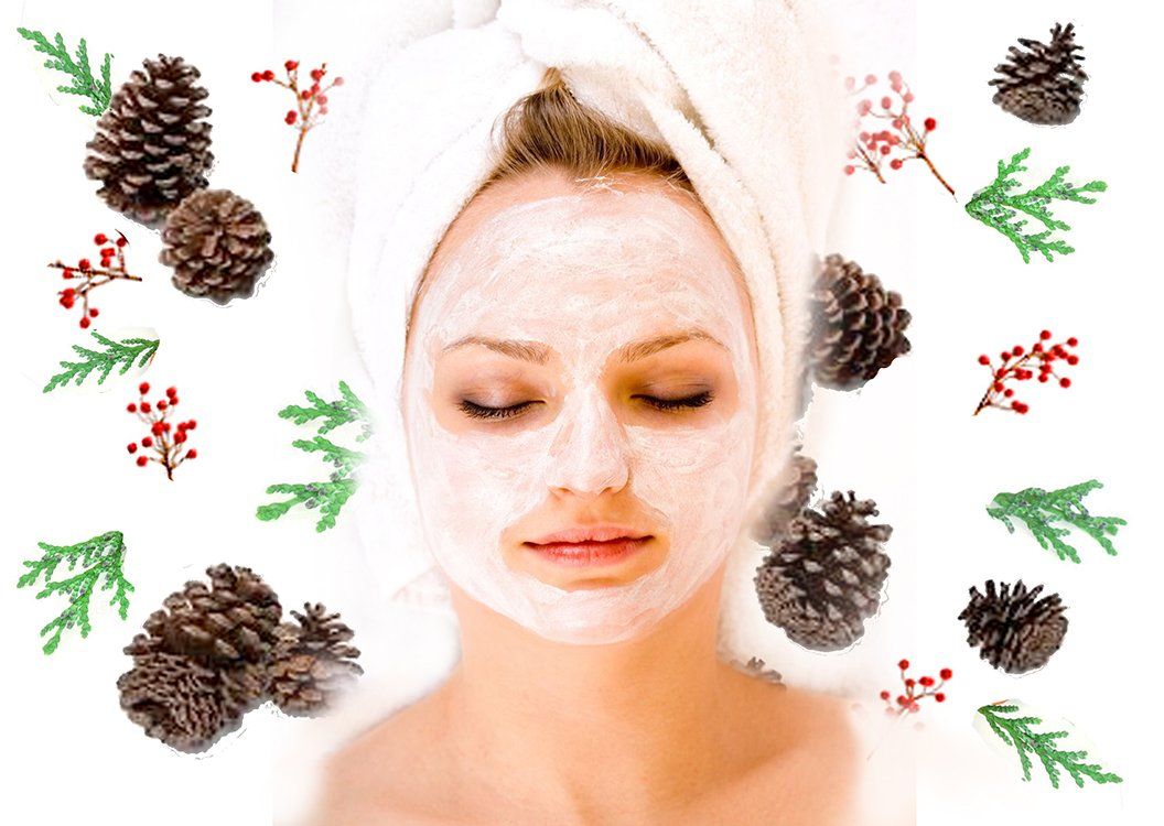 Woman with a face mask surrounded Christmas greenery and berries.