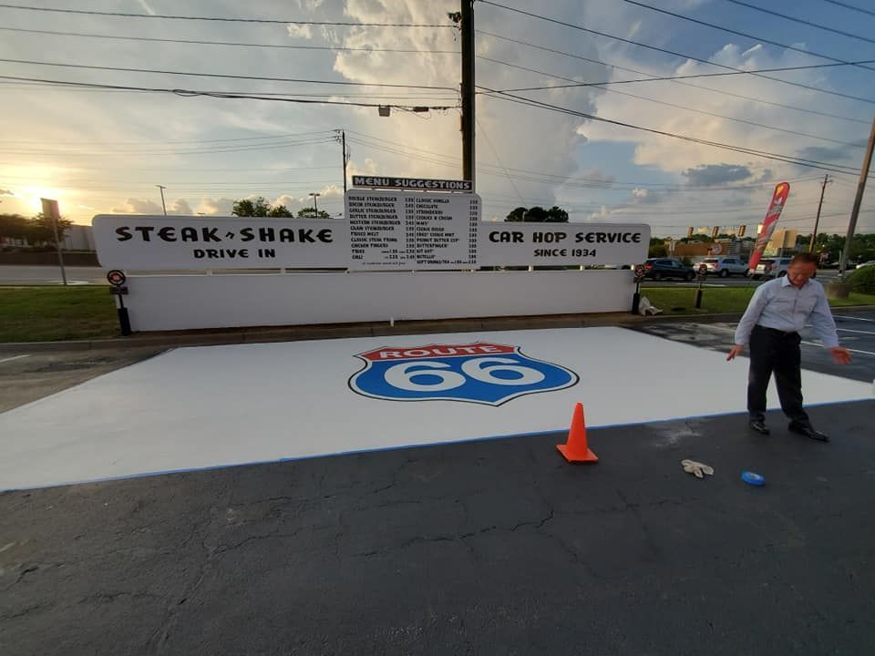 A Steak 'n Shake Drive-In with a Route 66 logo and a man gesturing.
