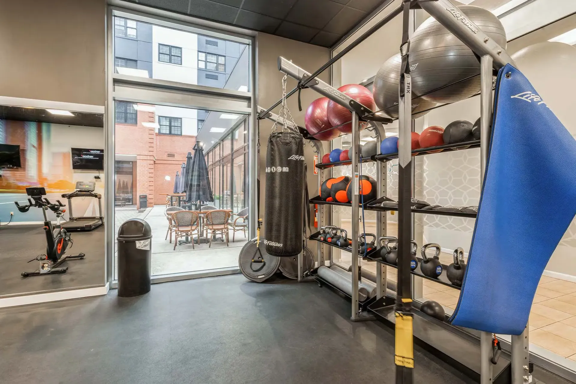 Indoor community gym with weights, a punching bag, and cardio equipment Parc at Lyndhurst in Lyndhurst, NJ.