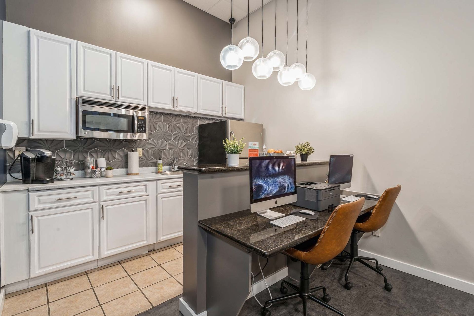 Shared kitchenette and work desk in a modern community lounge Parc at Lyndhurst in Lyndhurst, NJ.
