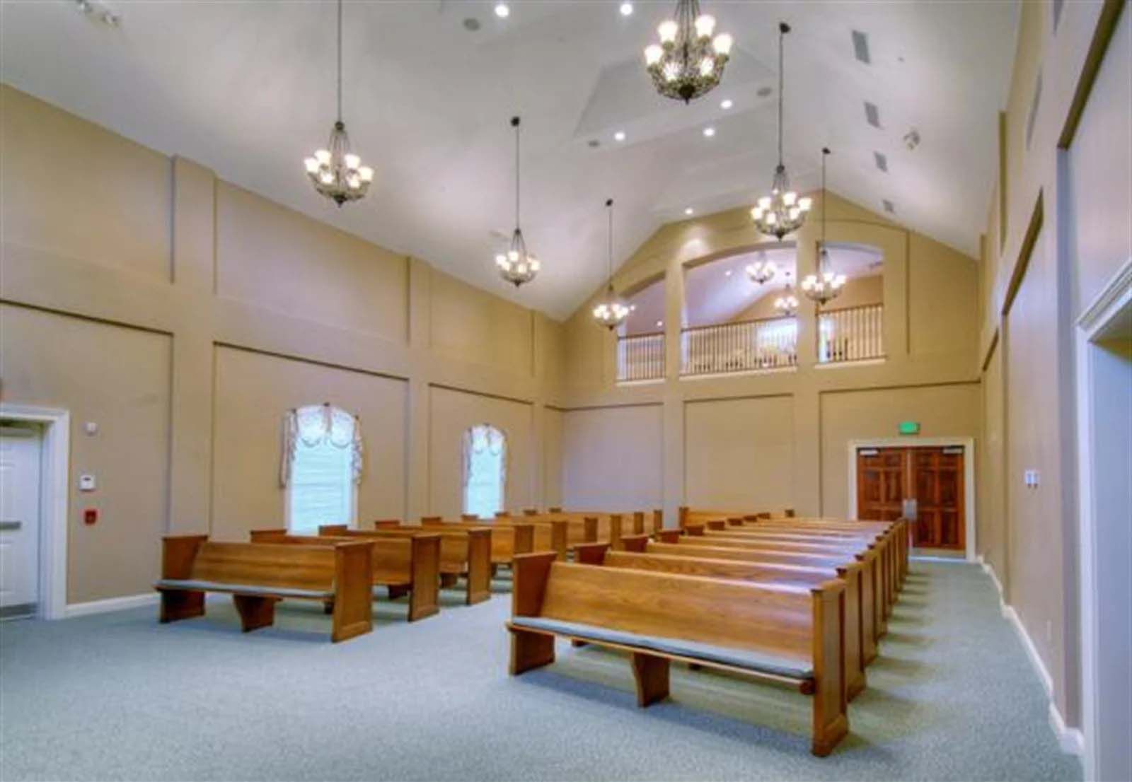 The inside of a church with rows of wooden benches