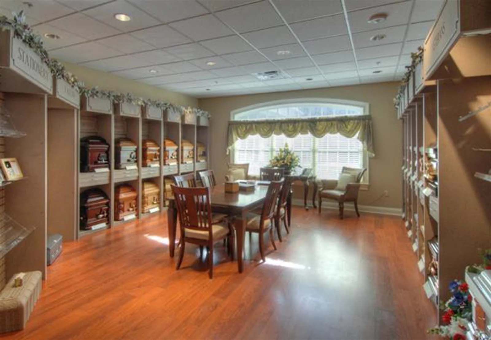 There is a table and chairs in the middle of the room.