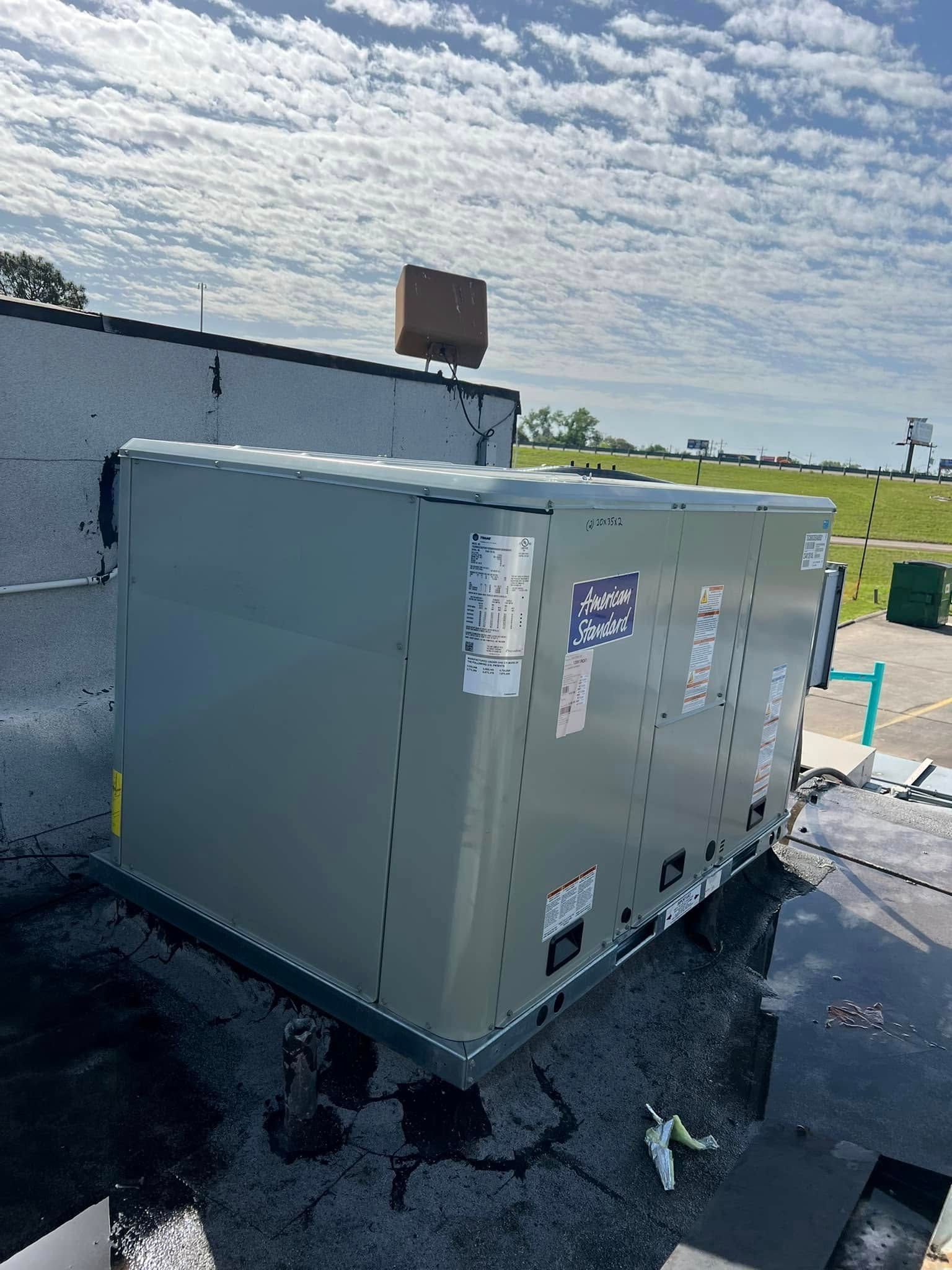 A large box is sitting on top of a roof.