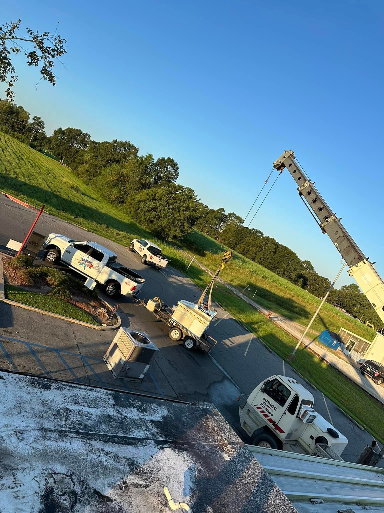 A crane is being used to remove hail from a roof.