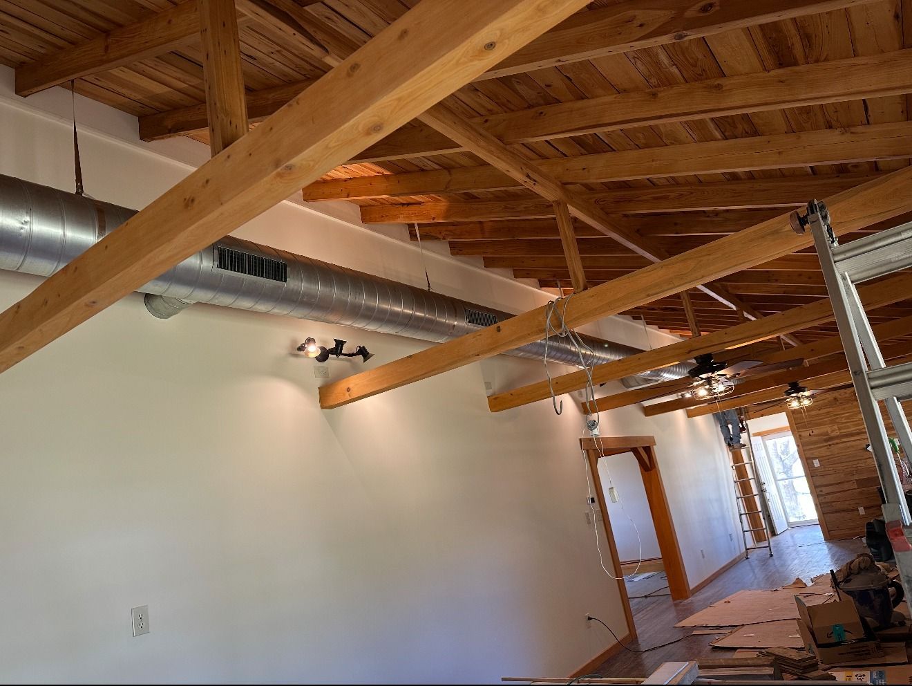 A room with a wooden ceiling and wooden beams.