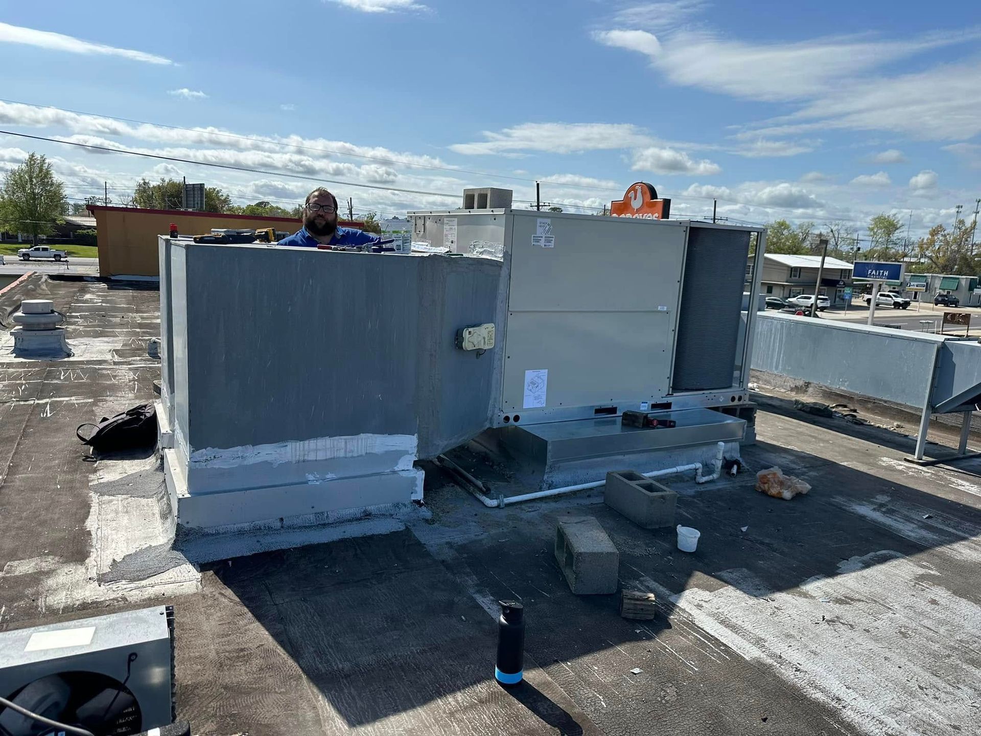 A man is working on the roof of a building.