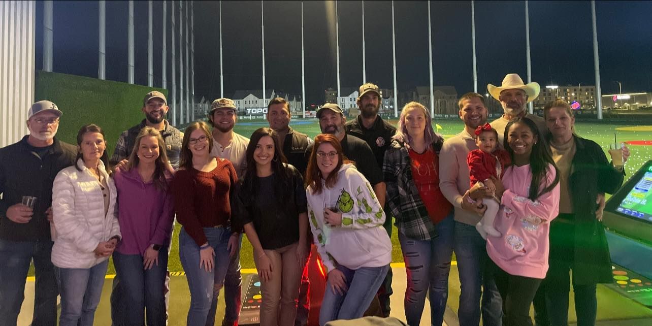 A group of people are posing for a picture on a golf course.
