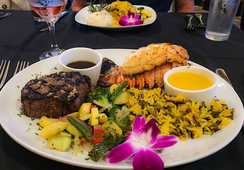 A plate of food with a purple flower on it