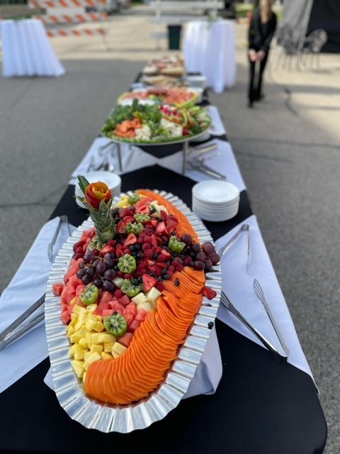 A buffet table with fruits and vegetables on it