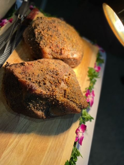 Two pieces of meat are sitting on a wooden cutting board