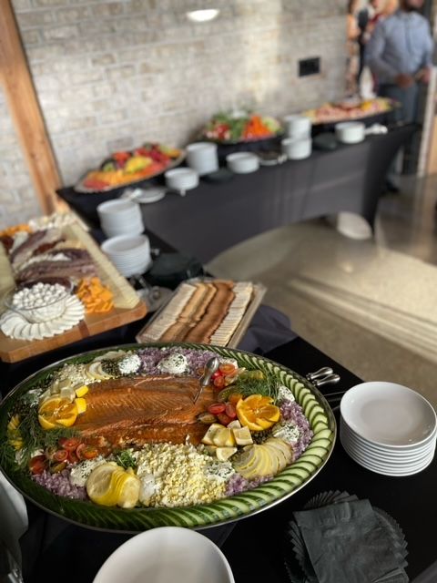 A buffet table with a large plate of food on it.
