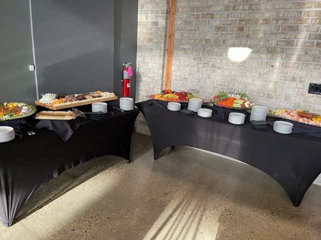A room filled with tables and plates of food.