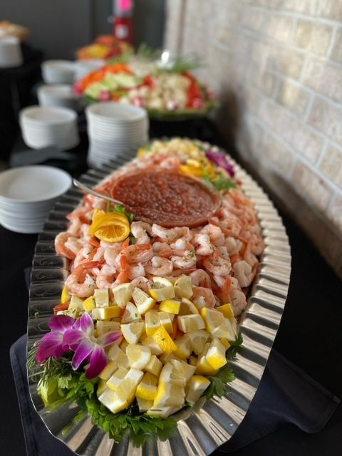 A tray of shrimp and lemons on a table