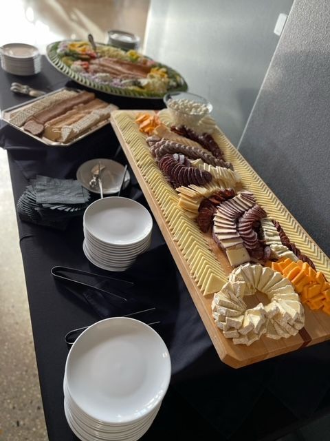 A table with plates and a tray of food on it