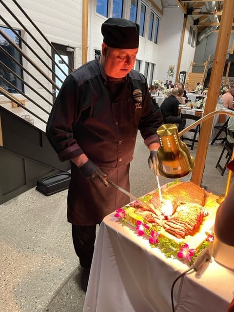 A chef is cutting a piece of meat on a table